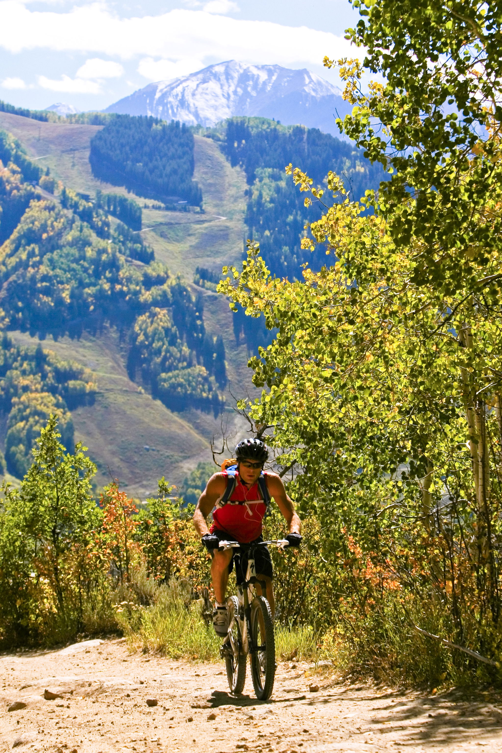 Mountain biking with summer ski slopes in the background