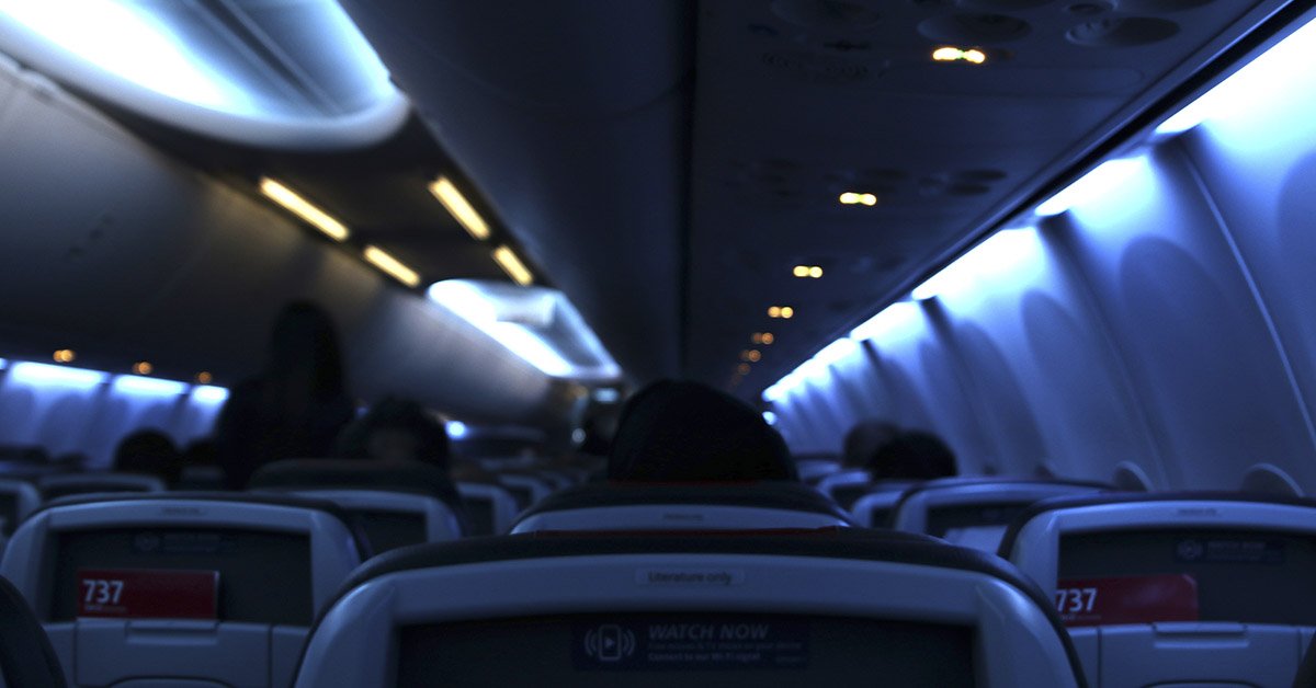 airplane cabin with lights dimmed