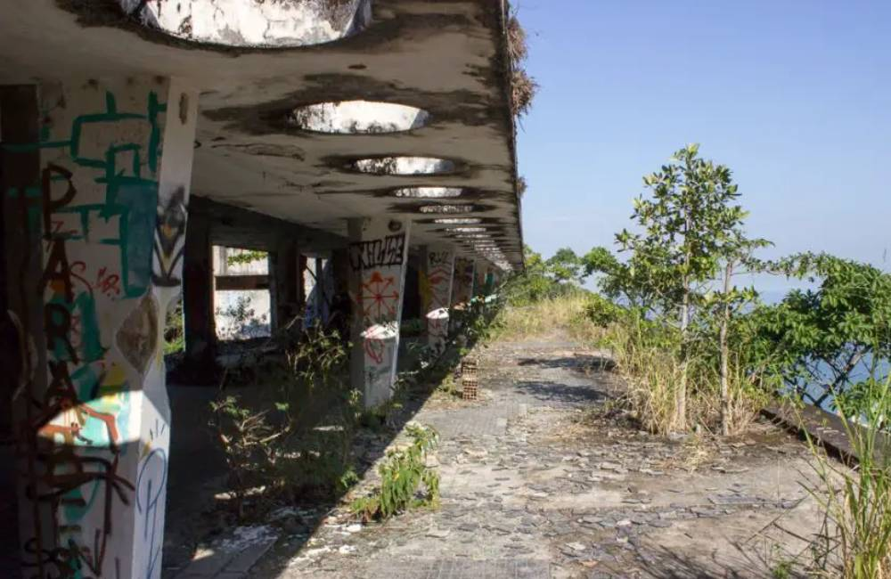Rio de Janeiro's "Skeleton Hotel," abandoned for nearly five decades, stands out amidst the lush greenery of the Atlantic Forest.