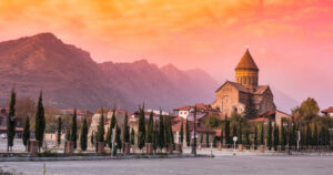 Sunset view of Svetitskhoveli Cathedral and mountains in sunset, Mtskheta, Georgia