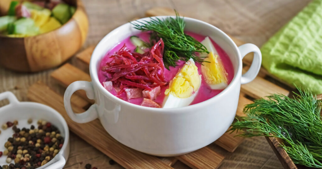 Shutterstock Cold beetroot soup with sausage and vegetables on a rustic wooden table.