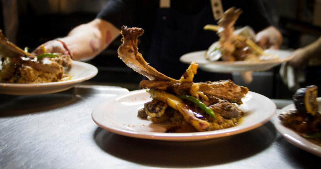 Shutterstock Delicious Patagonian lamb in its juices, served on creamy miso, mix of greens and crispy corn