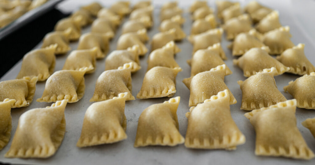Shutterstock Closeup of a tray of handmade Agnolotti pasta with prosciutto ham and bacon