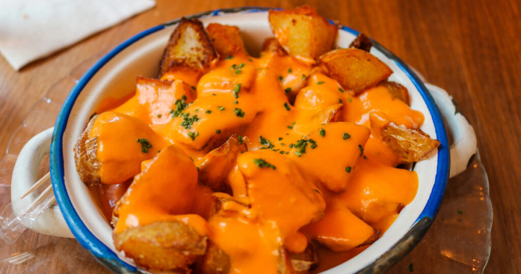 Shutterstock Patatas bravas, spicy potatoes, a typical Spanish dish with fried potato cubes and a spicy garlic sauce. Bilbao typical pintxo.