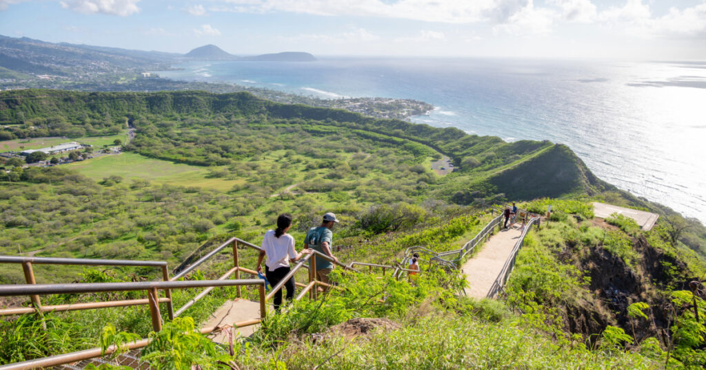 Shutterstock Tourists hiking on the Diamond Head lookout trail.
