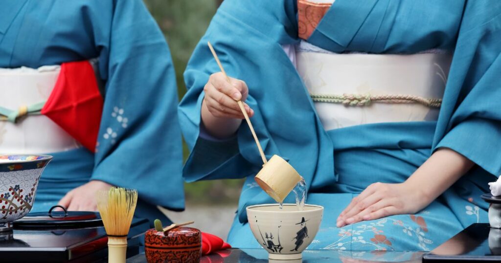 Shutterstock Japanese woman in traditional kimono preparing japanese green tea during a ceremony at garden