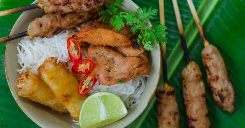 Shutterstock Bun thit nuong - Vietnamese grilled pork and rice noodles: It is a mix of vermicelli noodles, grilled pork, spring rolls, eaten along with vegetable and sour and sweet fish sauce.