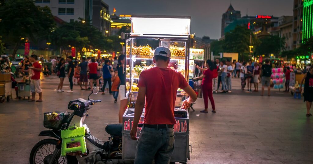 Shutterstock A street food vendor with a portable stall selling various types of food
