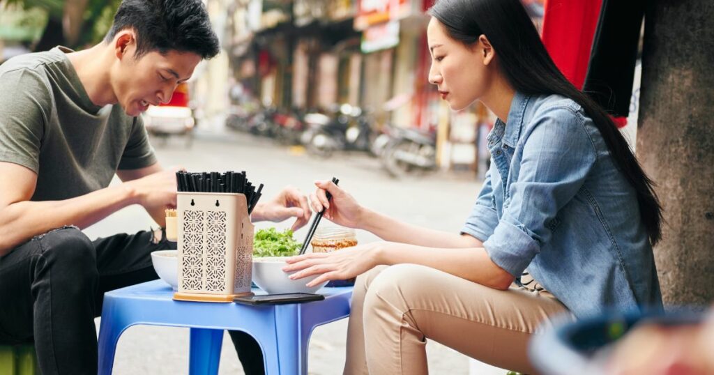 Shutterstock Tourists eating street food in Vietnam