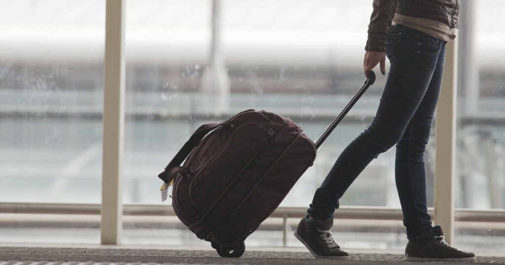 Shutterstock Woman carries her luggage at the airport