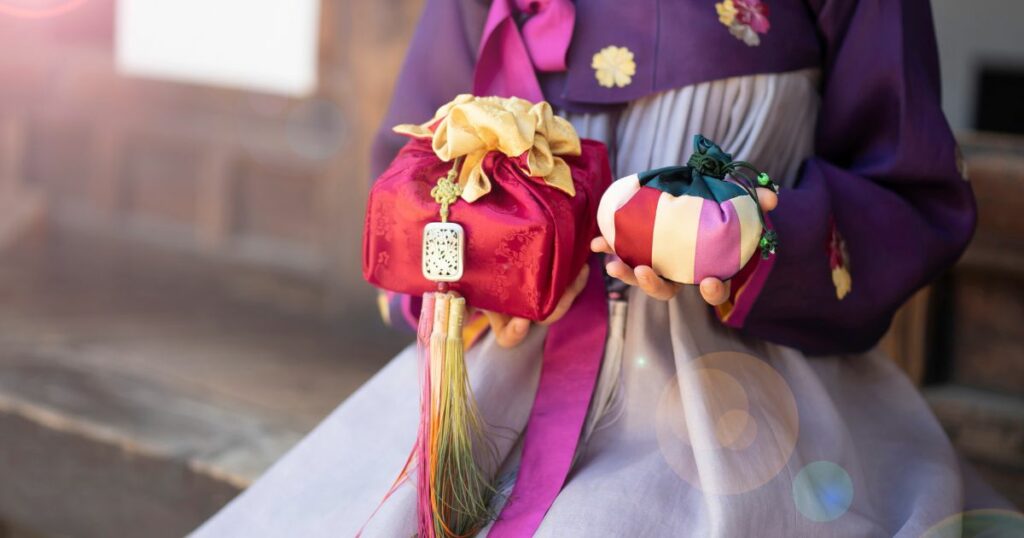 Shutterstock Woman in Korean traditional clothes holding gifts for the Korean Lunar Year