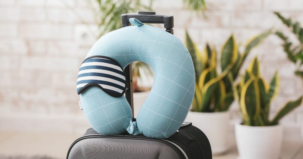 Shutterstock Travel pillow and sleep mask on a suitcase in a room