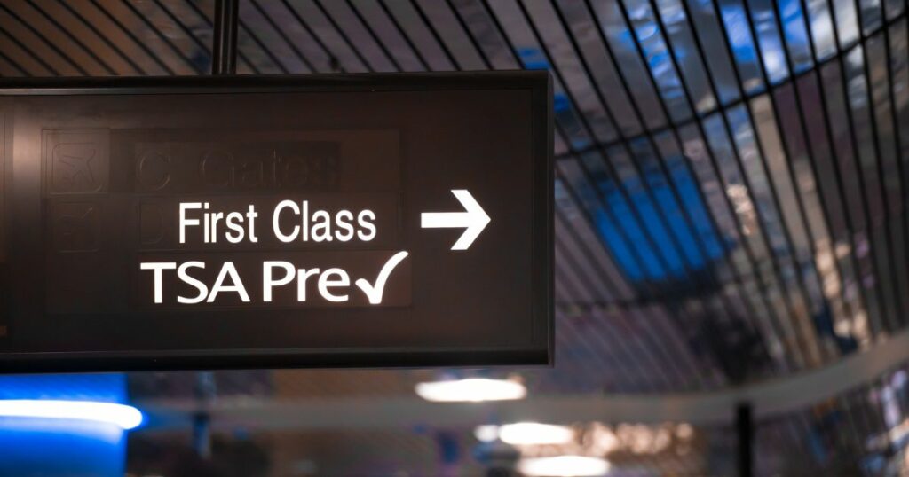 Shutterstock Overhead sign showing security check point lanes designated for first class and TSA Precheck passengers