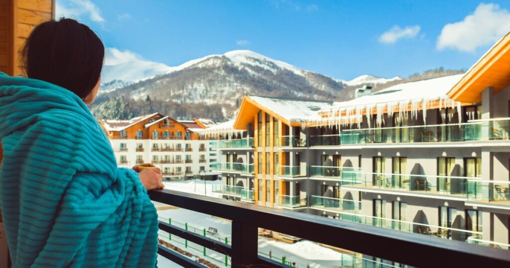 Shutterstock A female tourist standing on her hotel balcony in Georgia