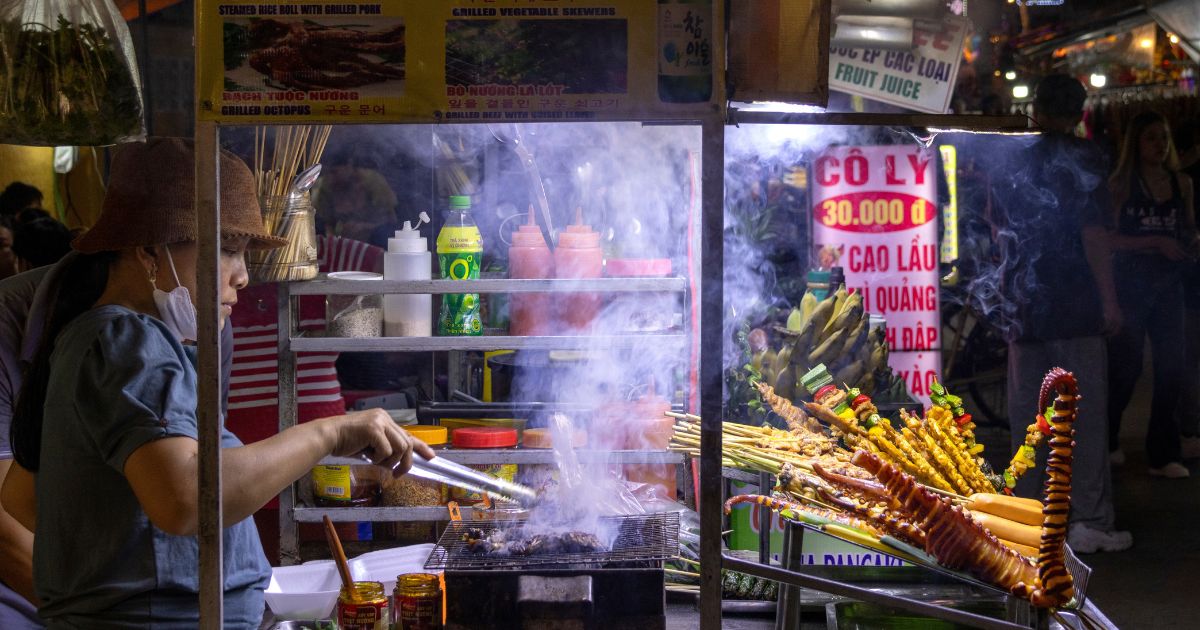 Hoi An, Vietnam- 29 Feb, 2024: Vietnam vendor selling street food in the night market. Vietnamese street food is plentiful, delicious and affordable
