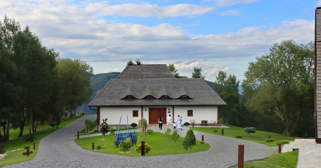 Shutterstock Tourists relaxing after a spa day in a rural resort in Bran, Romania. Traditional guesthouse from Romania. The house with traditional Romanian architecture