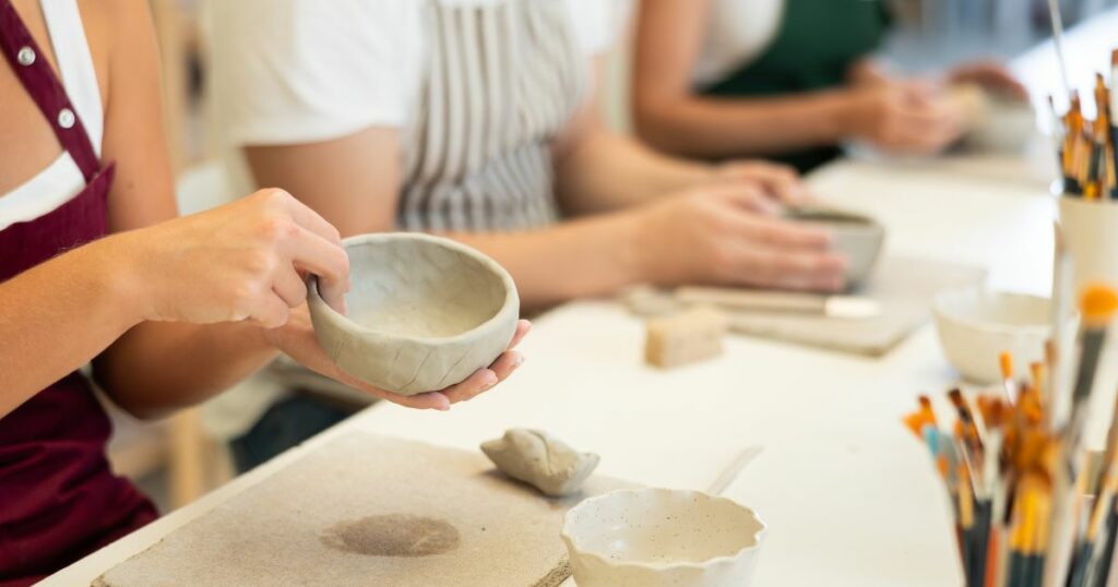 Shutterstock Female hands forming plate from wet clay in a pottery workshop