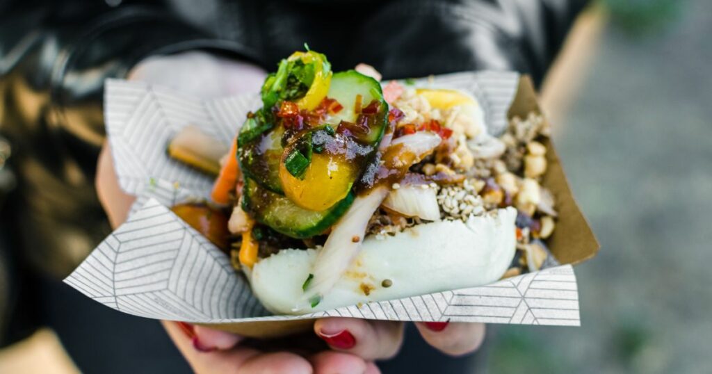 Shutterstock Close up photo of a traditional Vietnamese banh bao steamed bun with pork filling at a street food market