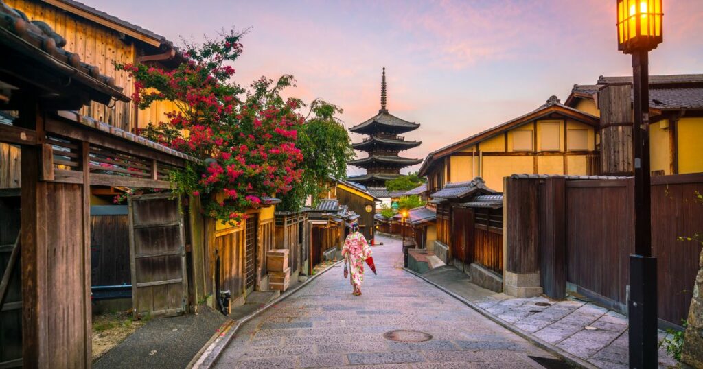 Shutterstock Japanese girl in Yukata with red umbrella in old town Kyoto, Japan