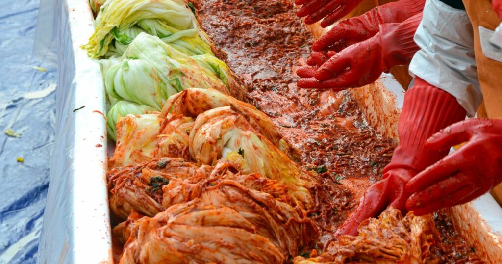 Shutterstock People making Kimchi in Seoul, Korea