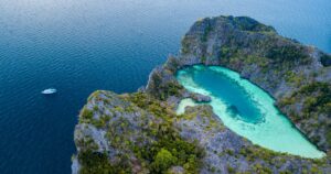 Aerial view of a spectacular shallow lagoon in the middle of a small tropical island in an archipelago