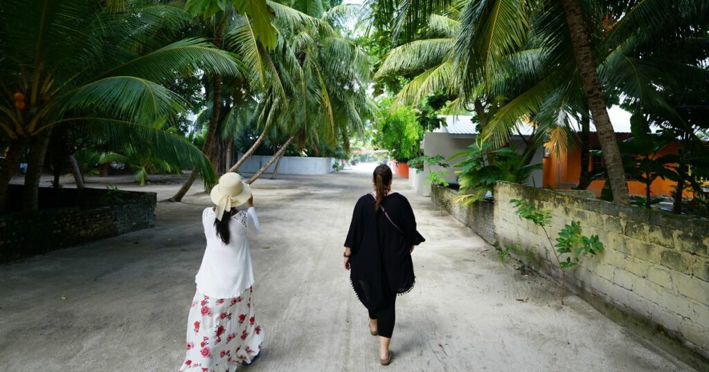 Shutterstock Tourists walking on a local island in the Maldives
