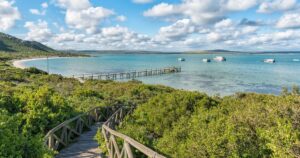 WEST COAST NATIONAL PARK, SOUTH AFRICA, AUGUST 20, 2018: The boardwalk to Kraalbaai at the Langebaan Lagoon on the Atlantic Ocean coast in the Western Cape Province. A jetty and houseboats are visible