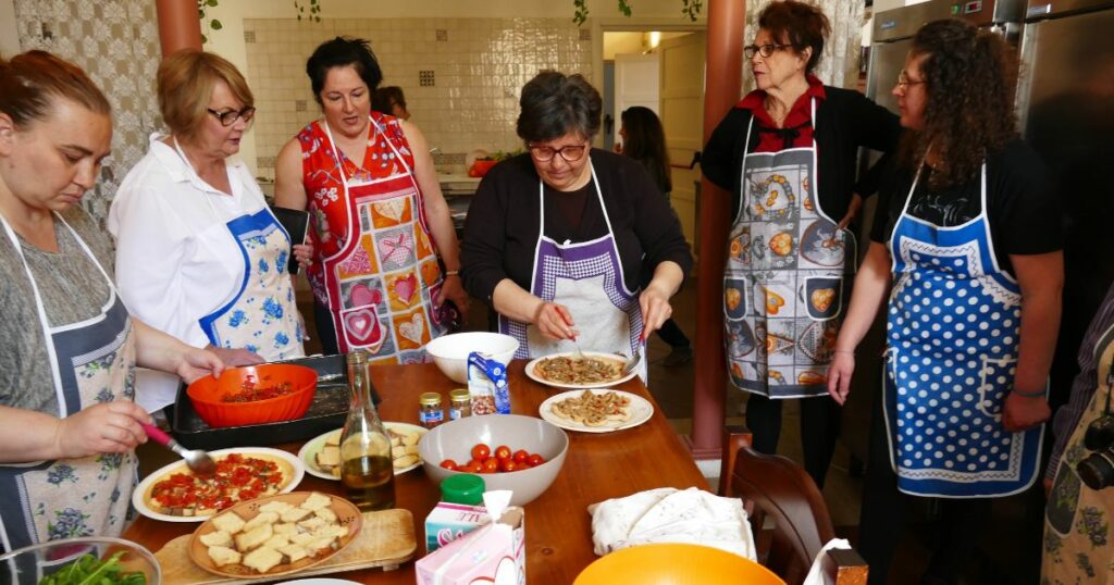 Shutterstock People making Italian dishes with grandmas in Puglia, Italy