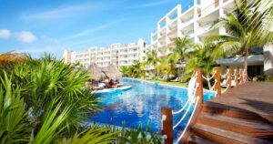 Swimming pool at caribbean resort. Exotic garden.