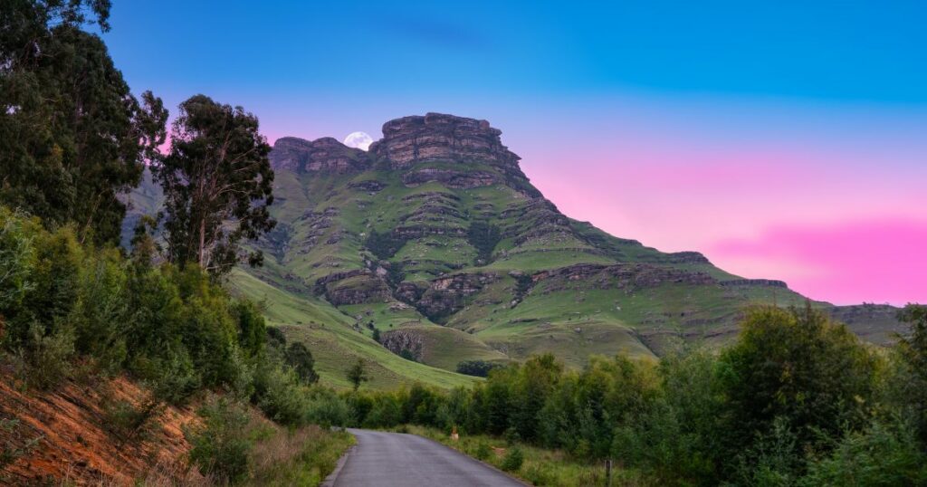 Shutterstock Winding road through Drakensberg valley with moon rising behind the mountain