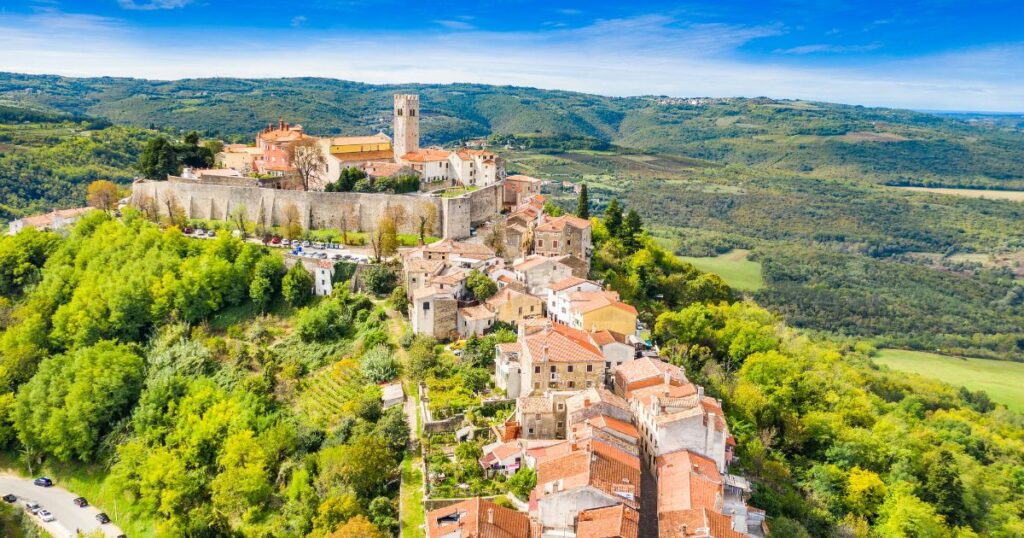 Shutterstock Beautiful old town of Motovun, stone houses and church tower bell, romantic architecture in Istria, Croatia, aerial view from drone