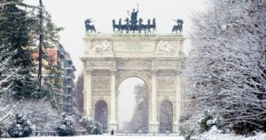 Peace Arch covered with snow in Sempione park, Milan, Italy.
