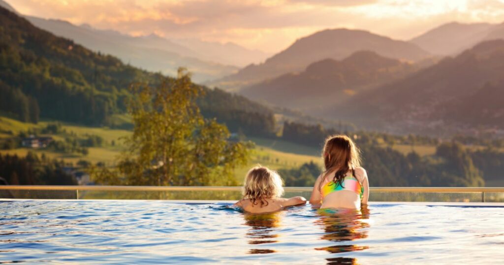 Shutterstock Kids play in outdoor infinity swimming pool