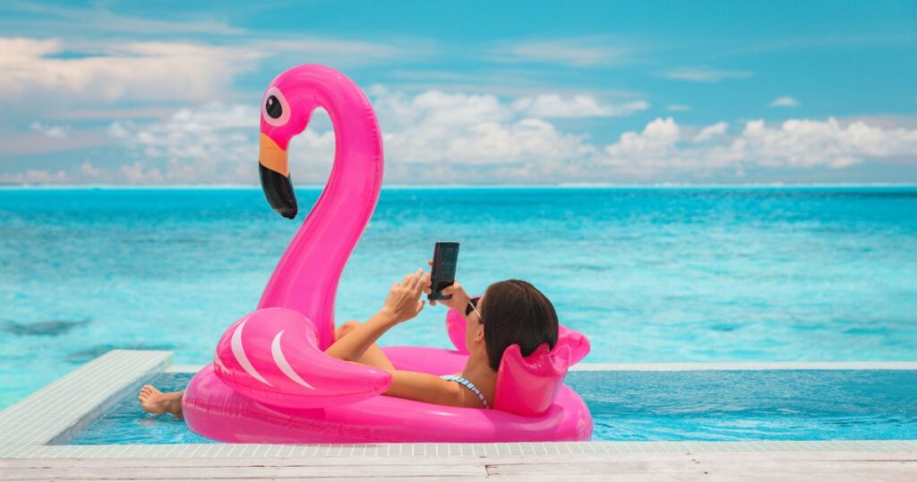 Shutterstock Woman floating in flamingo inflatable swimming pool toy at luxury resort