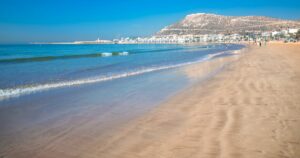 Agadir beach on the Atlantic African coast in the summertime with yellow sand and turquoise water in Morocco