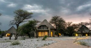 Okaukuejo camp lodges under a cloudy sky, Etosha National Park, Namibia.