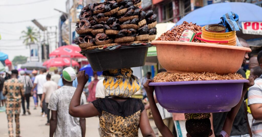 Young girl selling crayfish and smoked fish