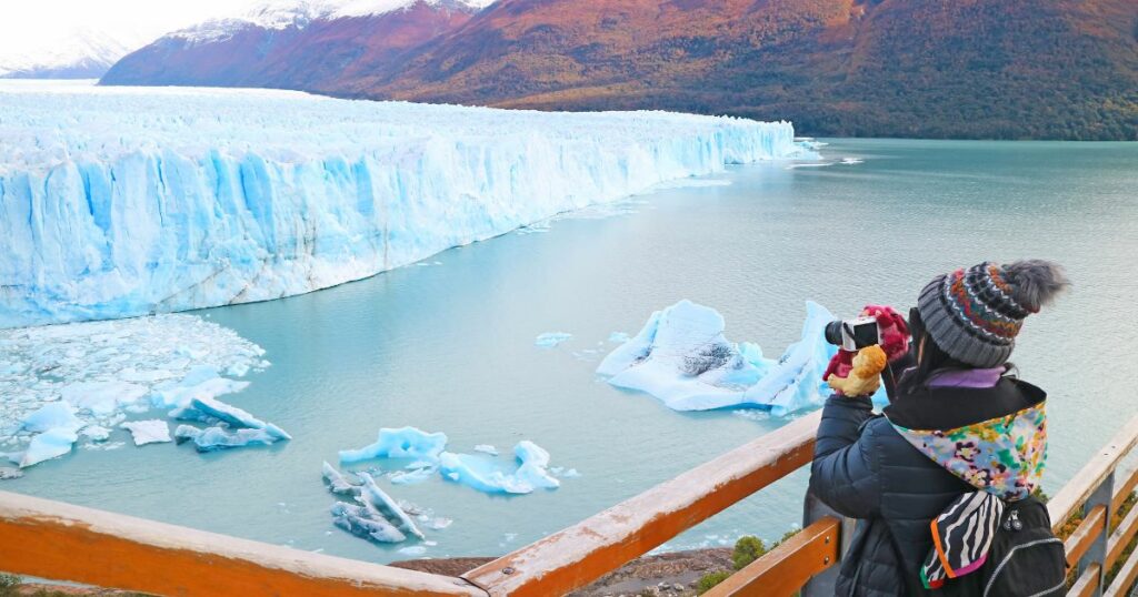 Shutterstock Female visitor shooting photos of Perito Moreno Glacier