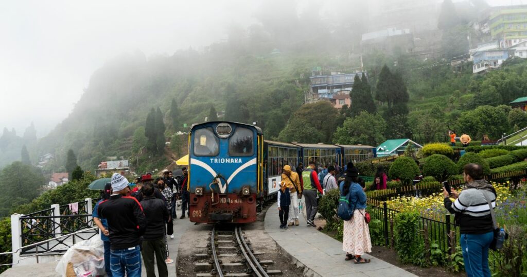 Shutterstock Tourists travel in a steam locomotive engine train of Darjeeling Himalayan Railway