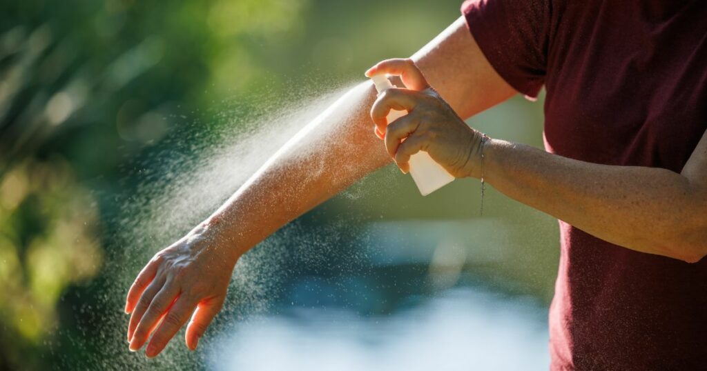 Shutterstock A person applying insect repellent on their arm