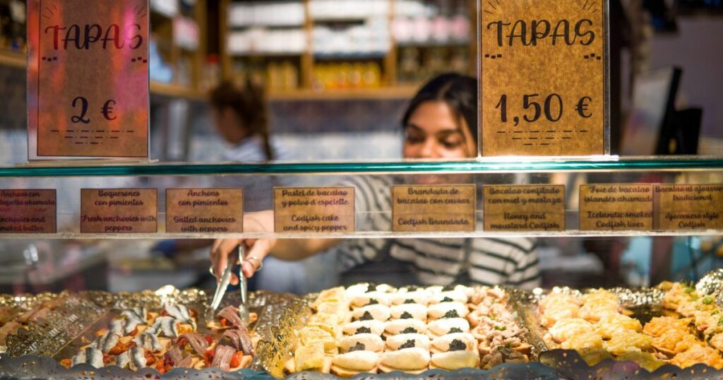 Shutterstock A woman serving tapas on a street in Madrid