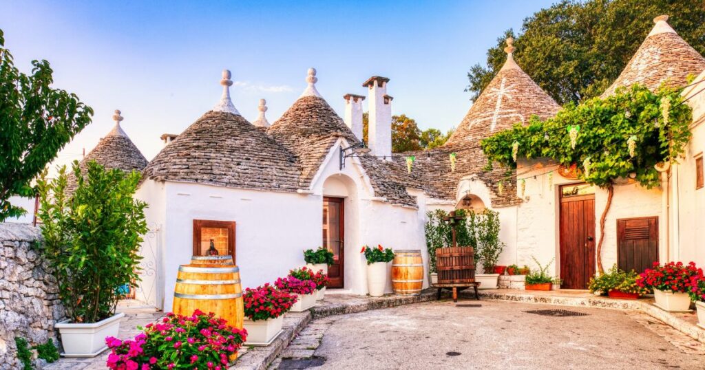 Shutterstock Famous Trulli Houses during a Sunny Day with Bright Blue Sky in Alberobello, Puglia, Italy