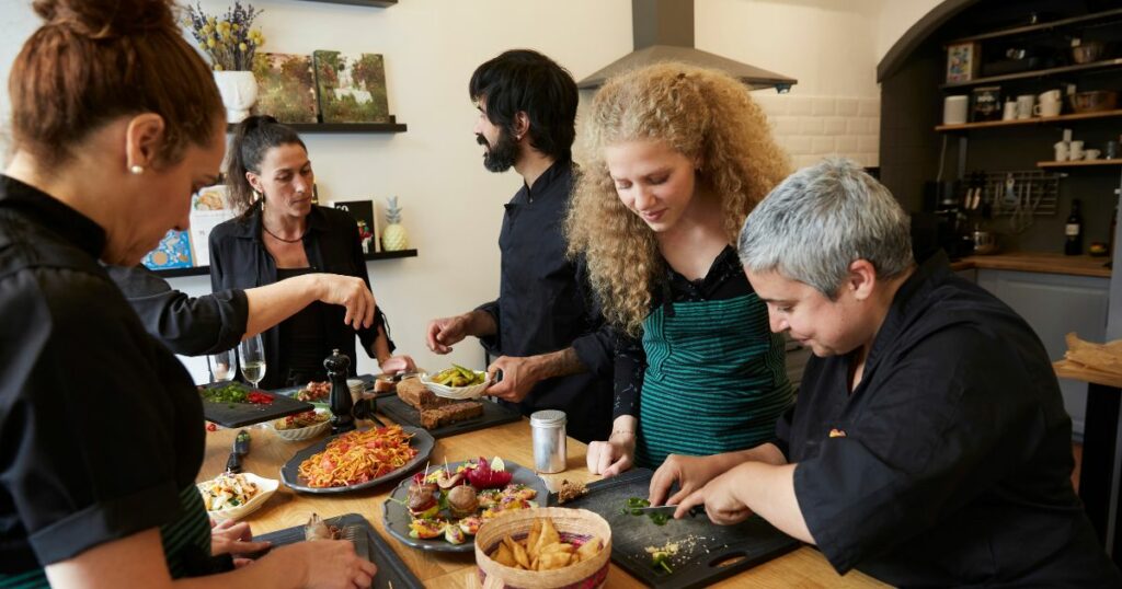 Shutterstock A group of people cooking together in a cooking class