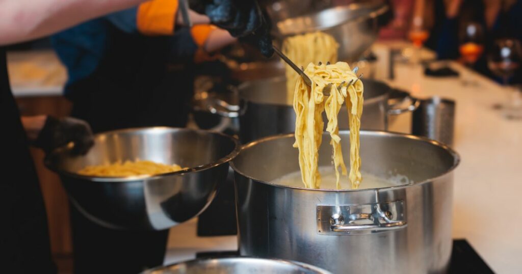 Shutterstock A person boiling pasta in a cooking class