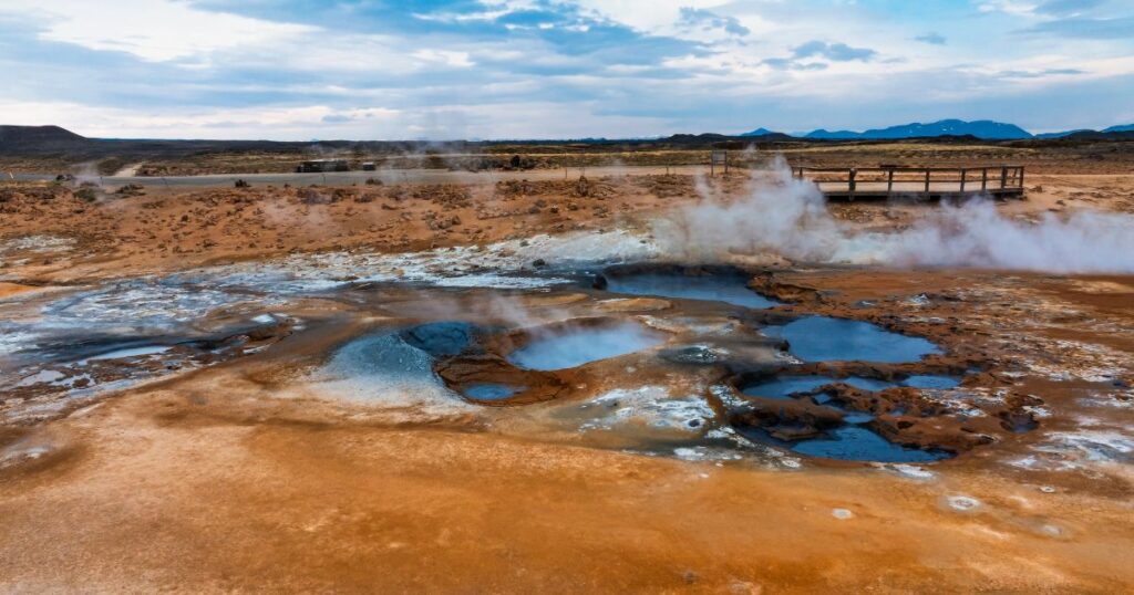 Shutterstock Aerial view of Hverir Geothermal Area in Iceland, capturing boiling mud pools, fumaroles, and the dramatic landscape of this geothermal hotspot near Lake Mývatn.