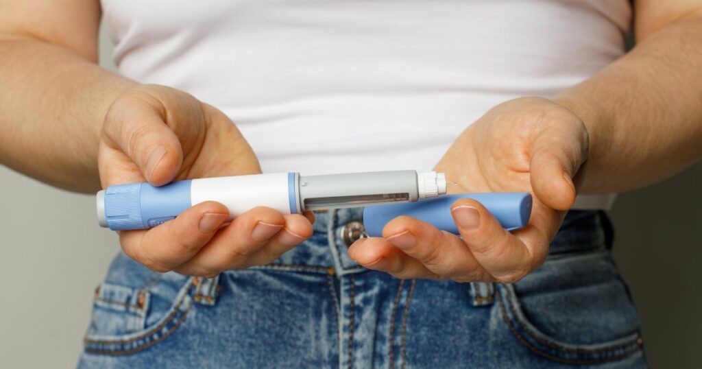 Shutterstock A person holding insulin