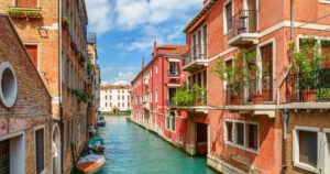 Beautiful view of colorful facades of old houses and the Rio Marin Canal from the Ponte de la Bergami in Venice, Italy. Venice is a popular tourist destination of Europe.