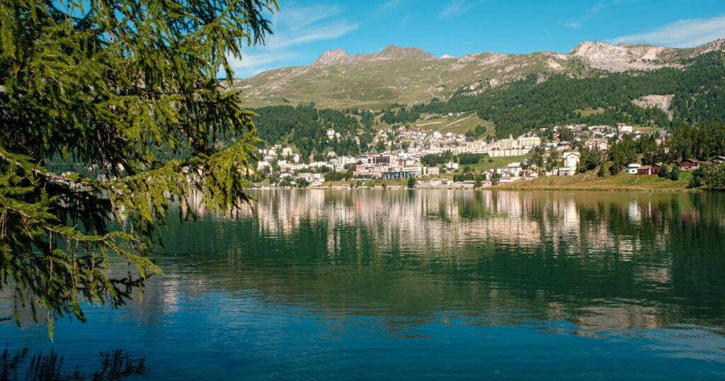 Shutterstock Scenic view on the St. Moritz mountain lake with the alpine resort on the other side on a bright summer day.