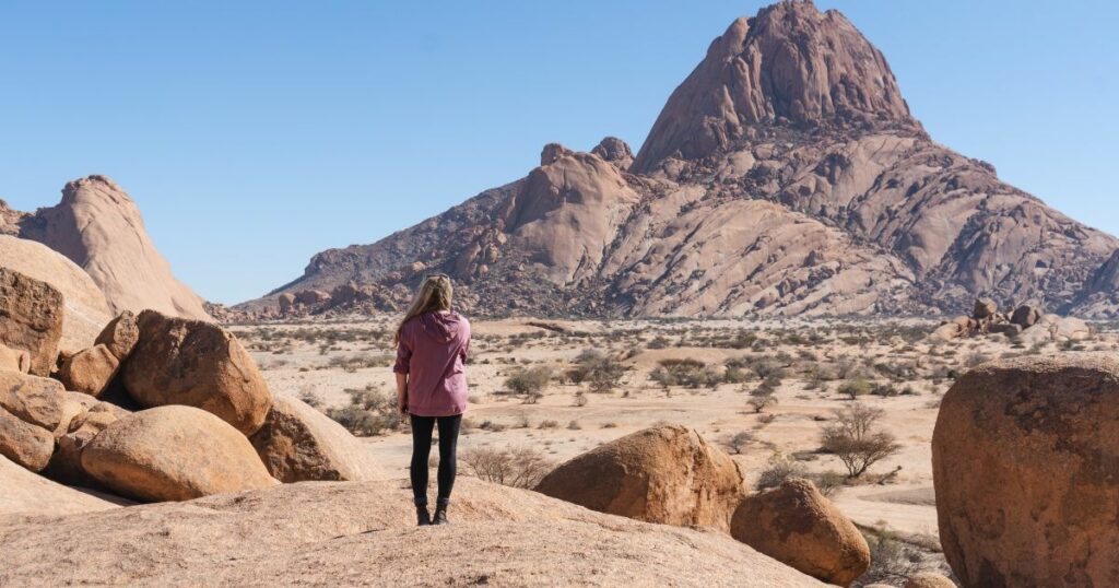 Shutterstock Woman standing looking at Spitzoppe, Namibia