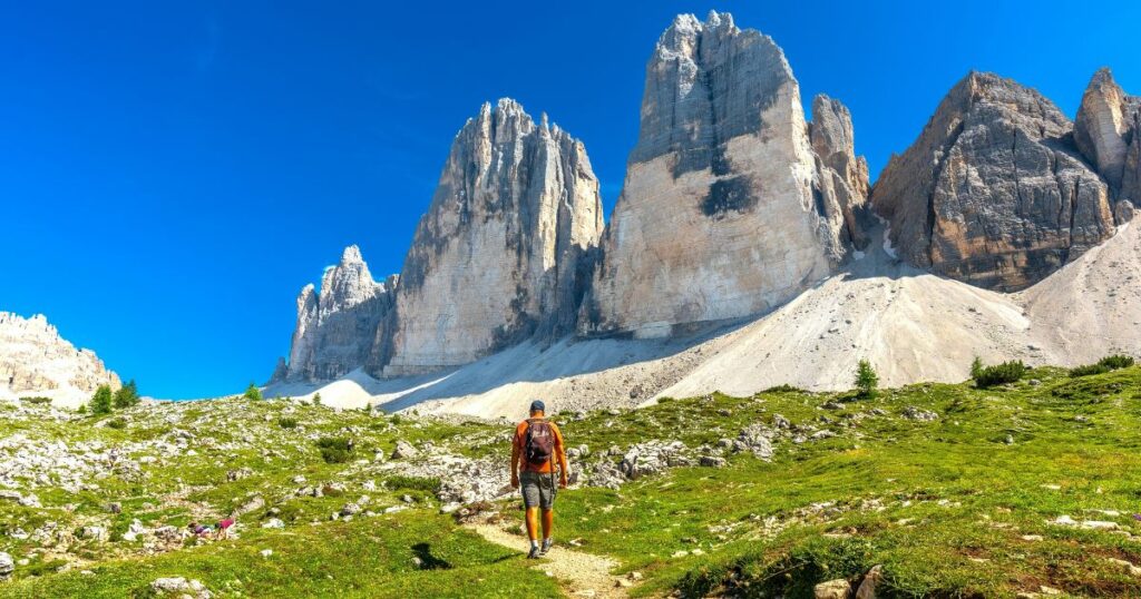 Shutterstock Tourist enjoying a summer hike on a scenic trail